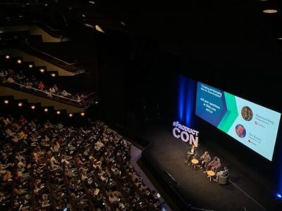 a conference with stadium seating and a large stage