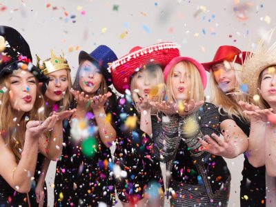 a group of people with hats and confetti at a party